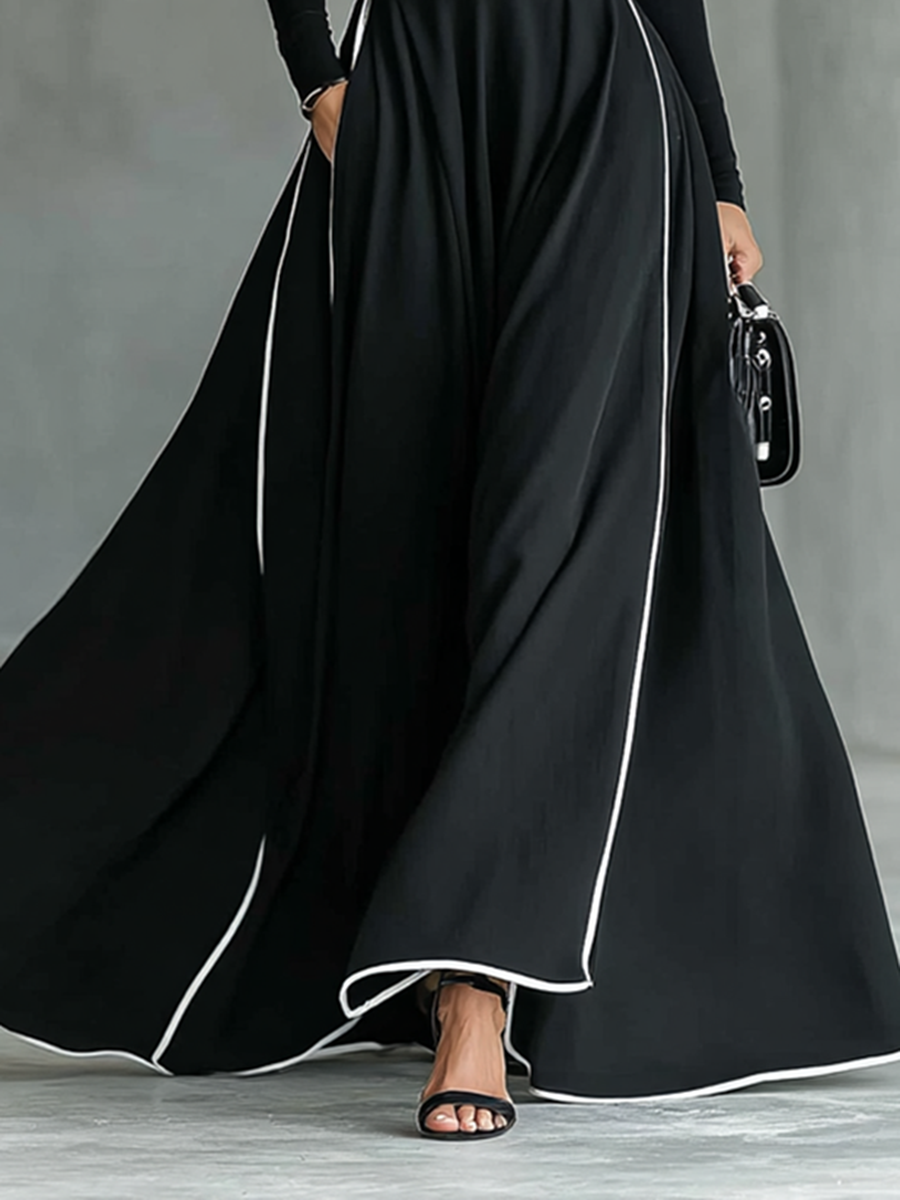 Gina – Vestido Largo Negro con Costuras Blancas y Cuello Alto, Manga Larga, Cintura Ceñida
